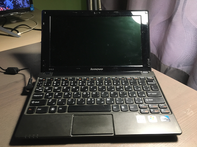 The keyboard is etched with Arabic letters